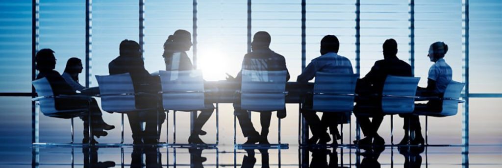 silhouettes of business people in a conference room.